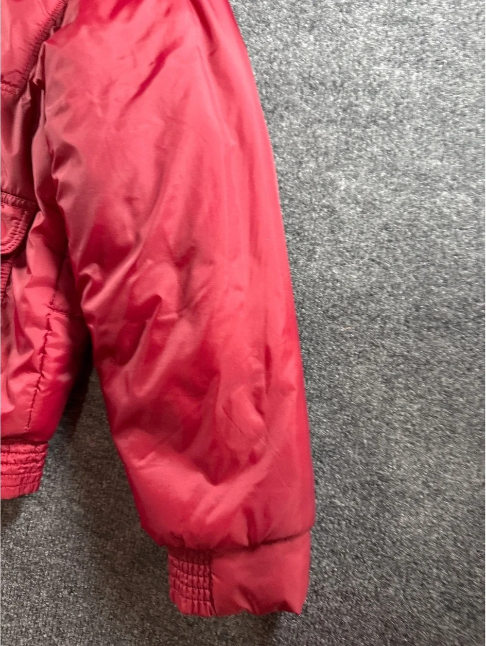 Red Quilted Puffer Jacket with Multiple Pockets and Zip Closure